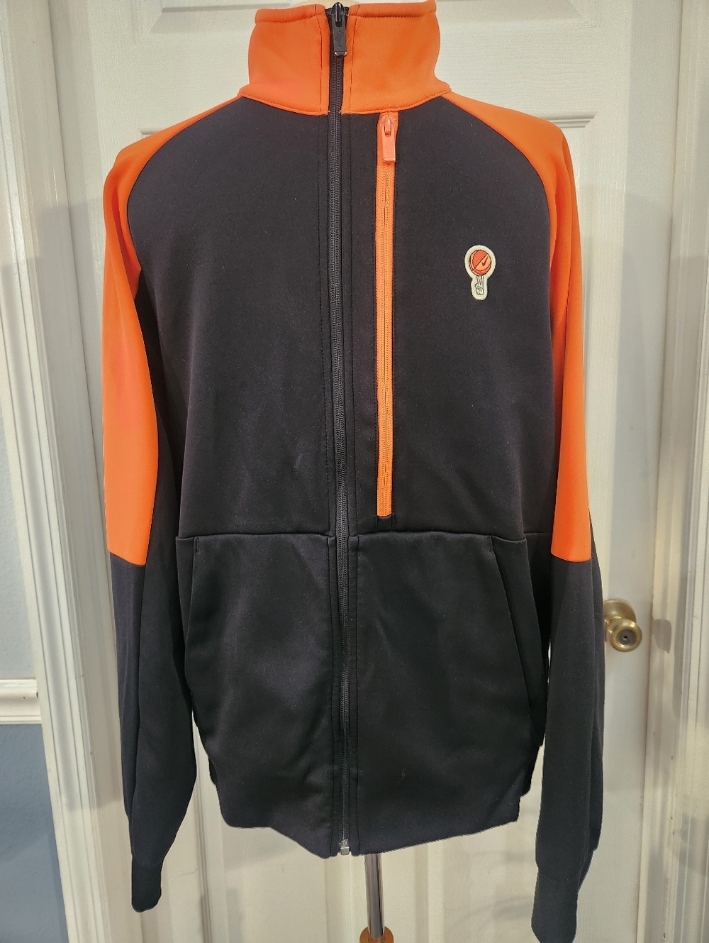 Nike Men's Half Zip Peace Love & Basketball Athletic Jacket in black and orange